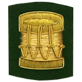 Hand Embroidered gold wire on green cloth drum insignia badge