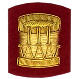 Hand Embroidered gold wire on red cloth drum insignia badge