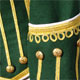 Green piper doublet with scrolling gold braid trim cuff detail